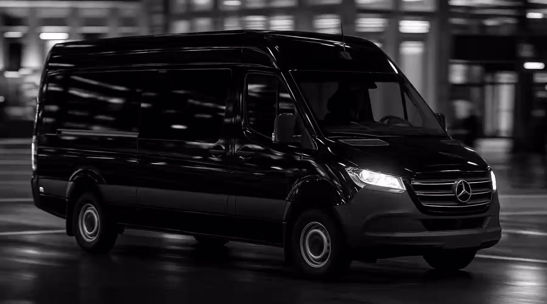 A black Mercedes-Benz Sprinter van on a city street