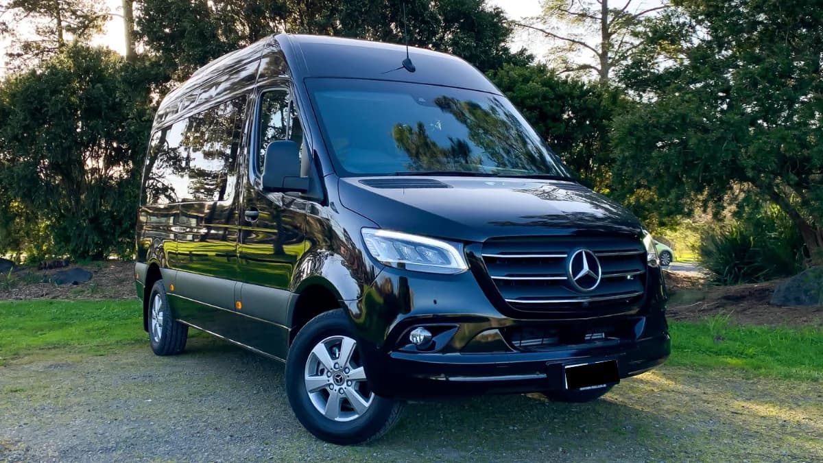Chauffeur beside a Sprinter van in New York