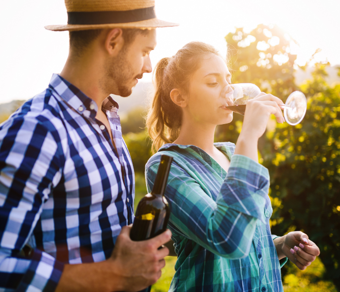 Man and woman tasting wine in a vineyard in wine tasting tours in new york